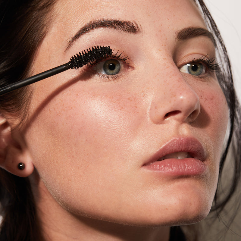 A woman applying The Mascara from Jones Road Beauty