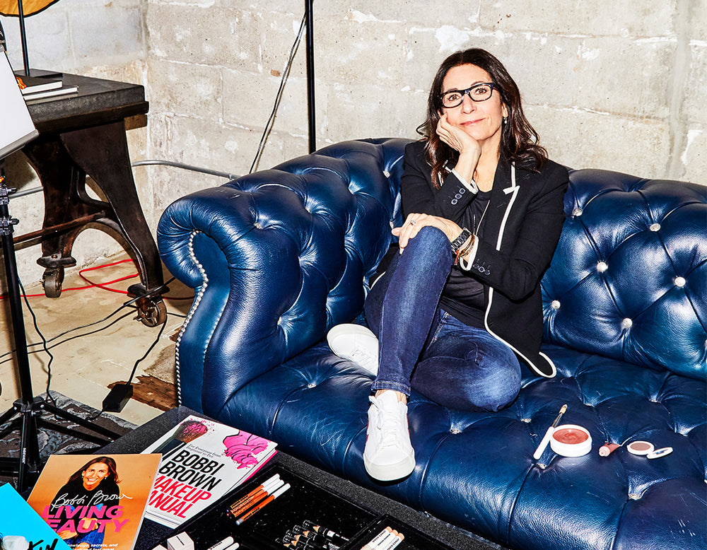 Jones Road Beauty Founder, Bobbi Brown, sitting on a blue couch