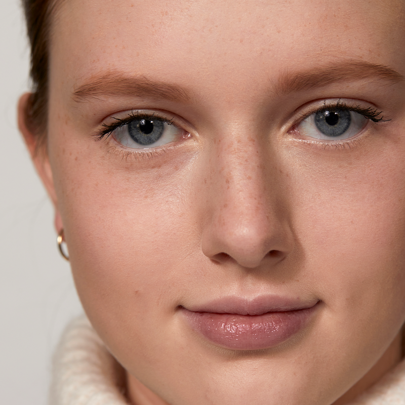 A woman showing her results after using The Brow Pencil in Blonde by Jones Road Beauty
